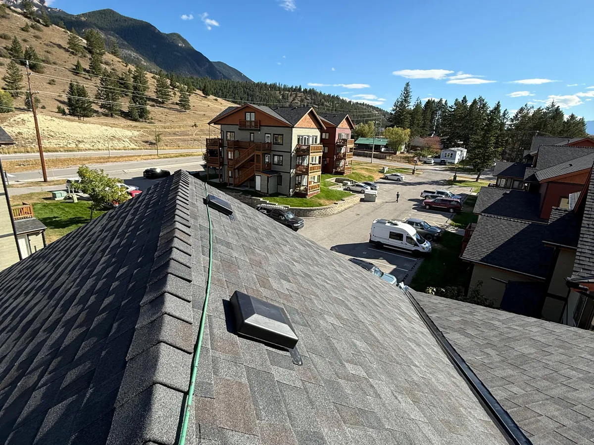 New roof on a Radium Hot Springs townhome with the Rocky Mountains behind