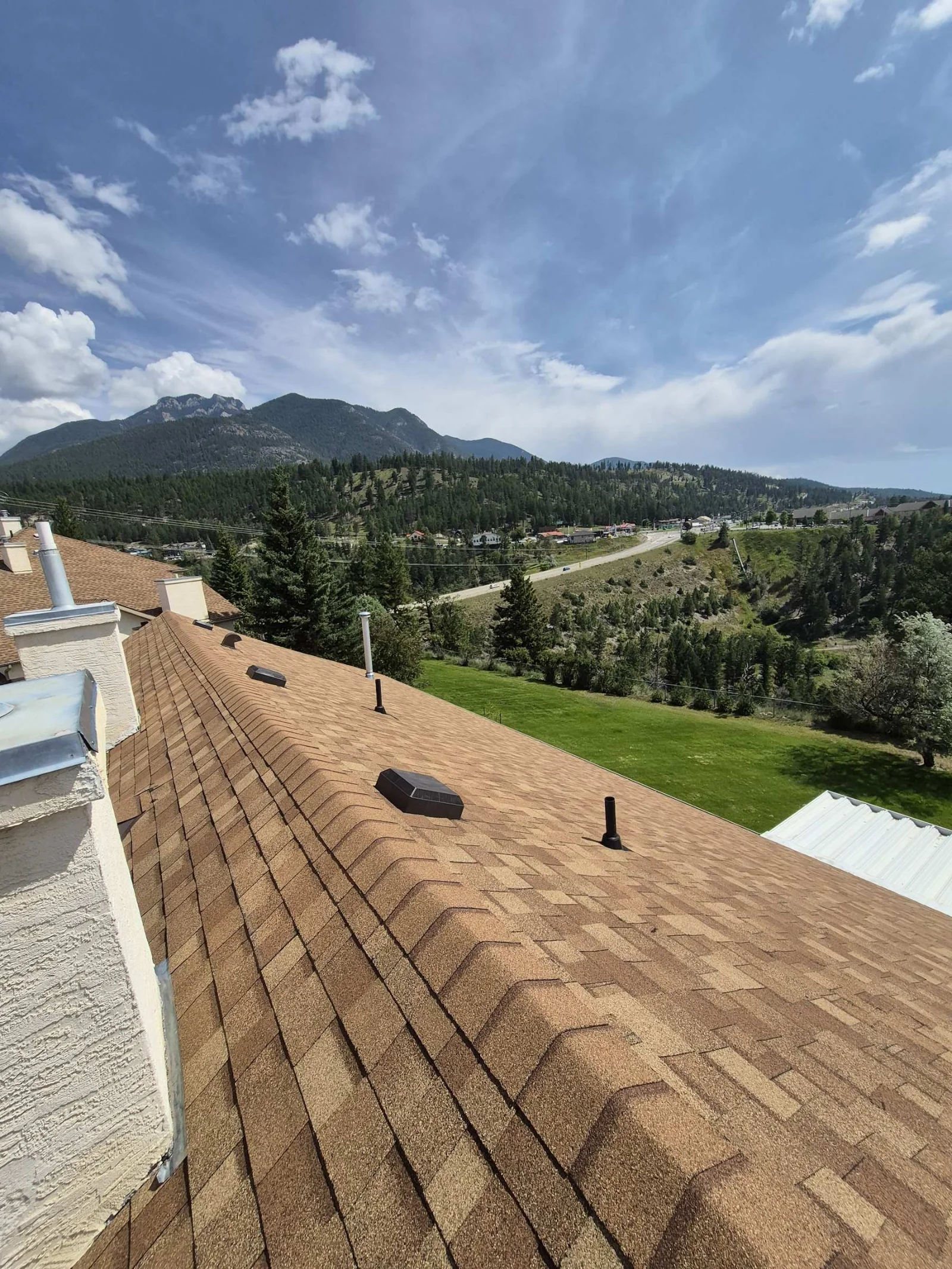 A long run of new ridge cap on the finished roof, Radium Hot Springs, BC