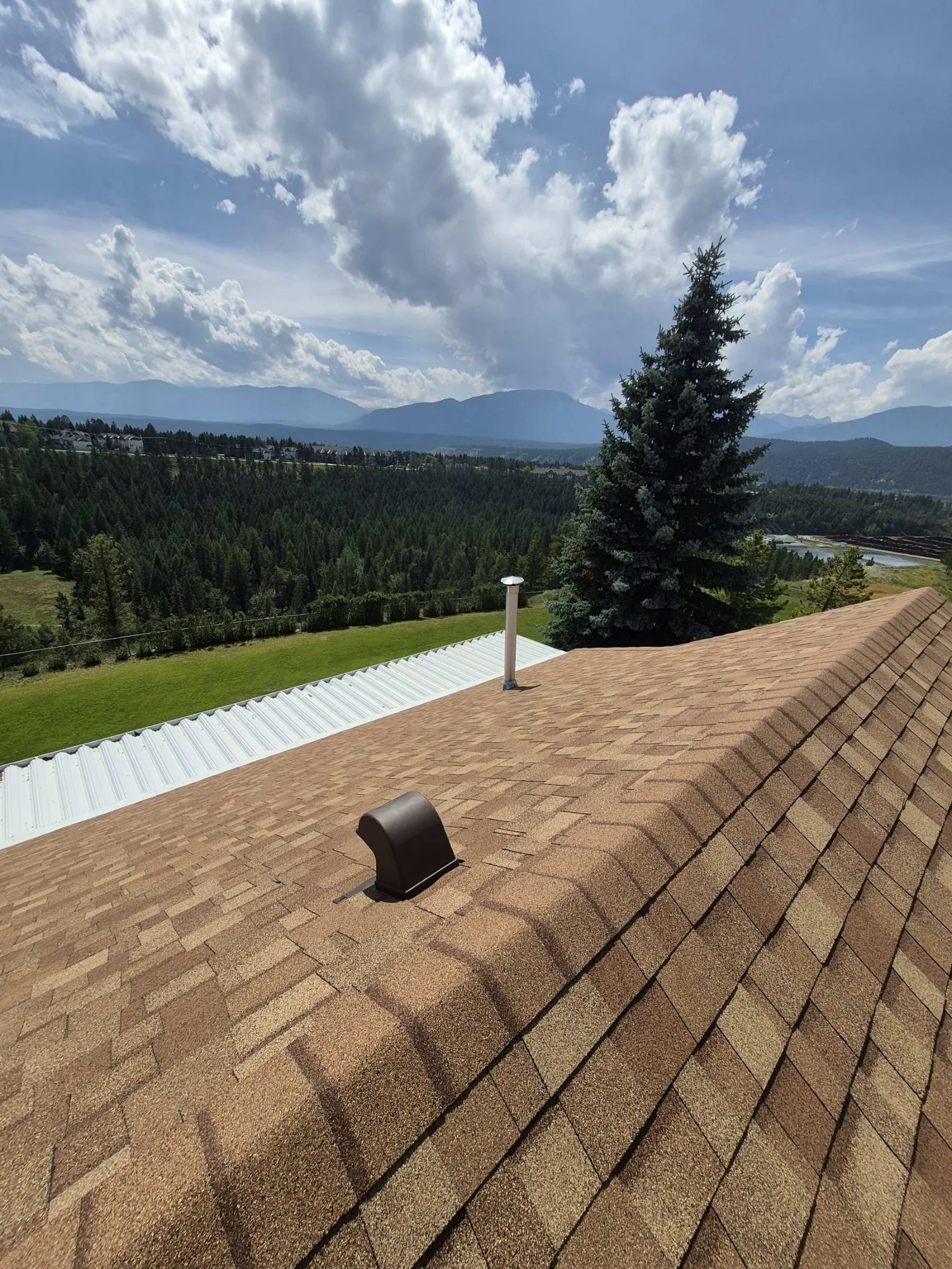 New architectural shingles with the mountains behind, Radium Hot Springs, BC
