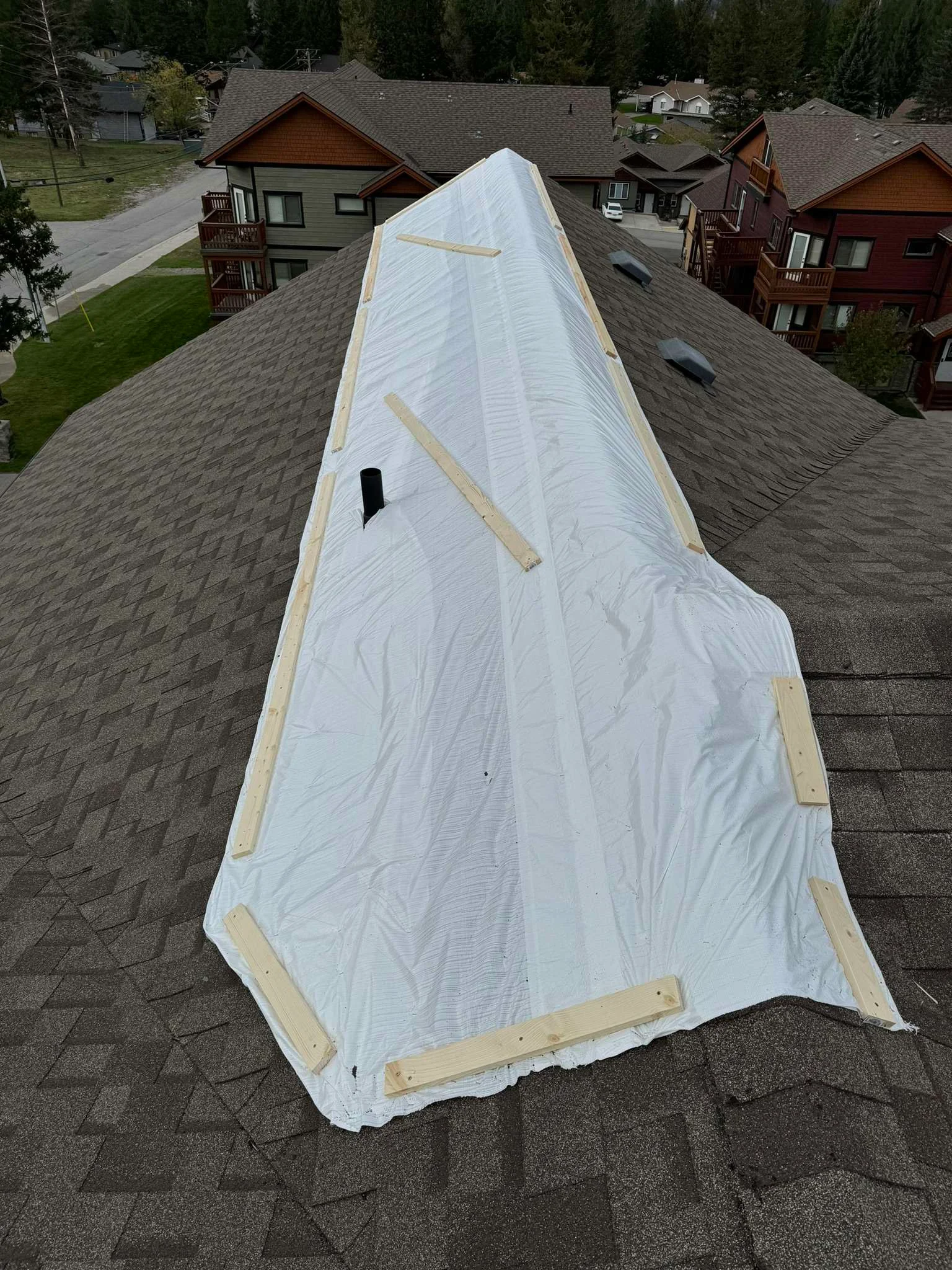 Temporary protection over a damaged section of the old roof before replacement, Radium Hot Springs, BC
