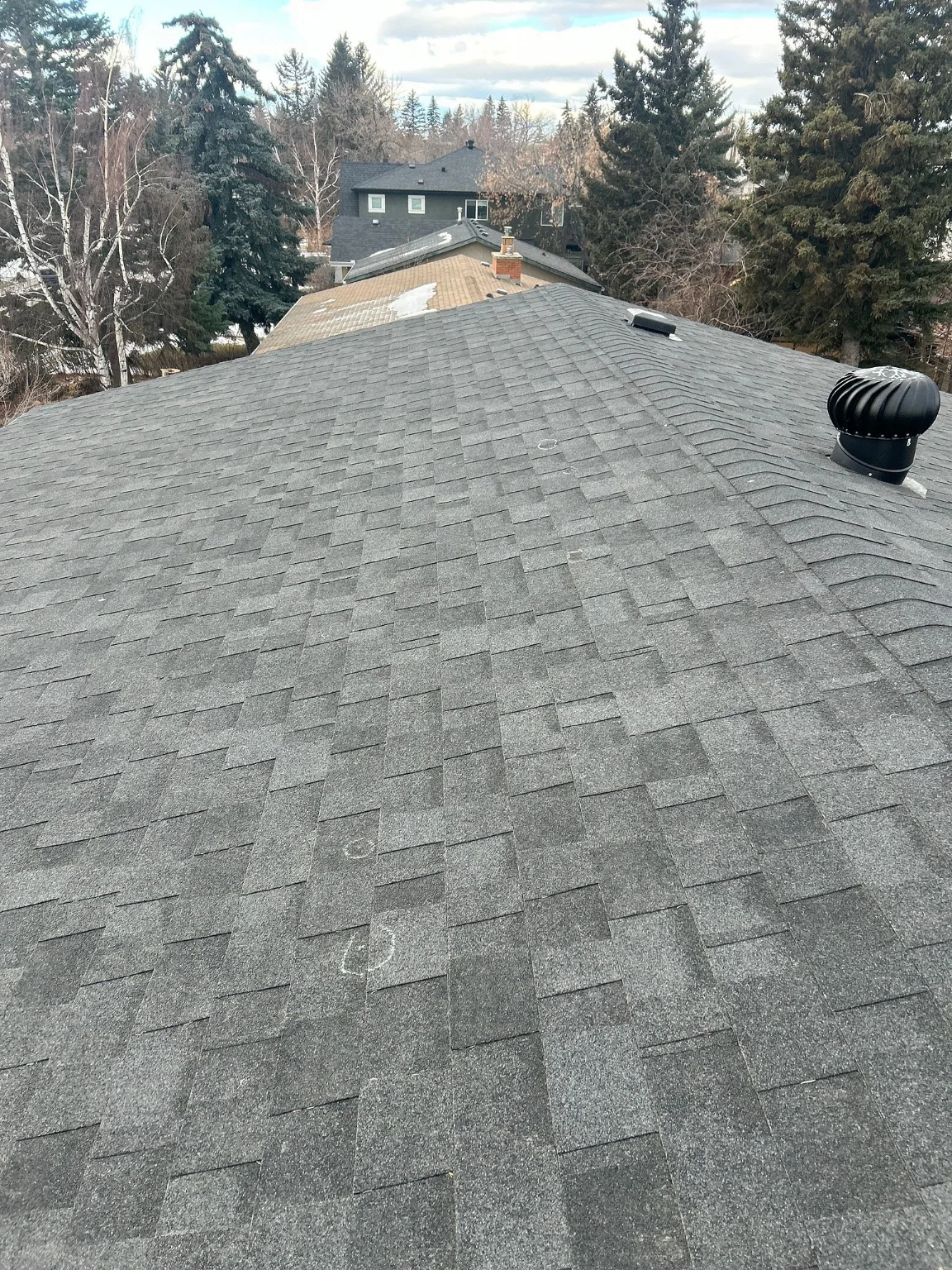 An asphalt shingle roof checked before a planned addition, southwest Calgary