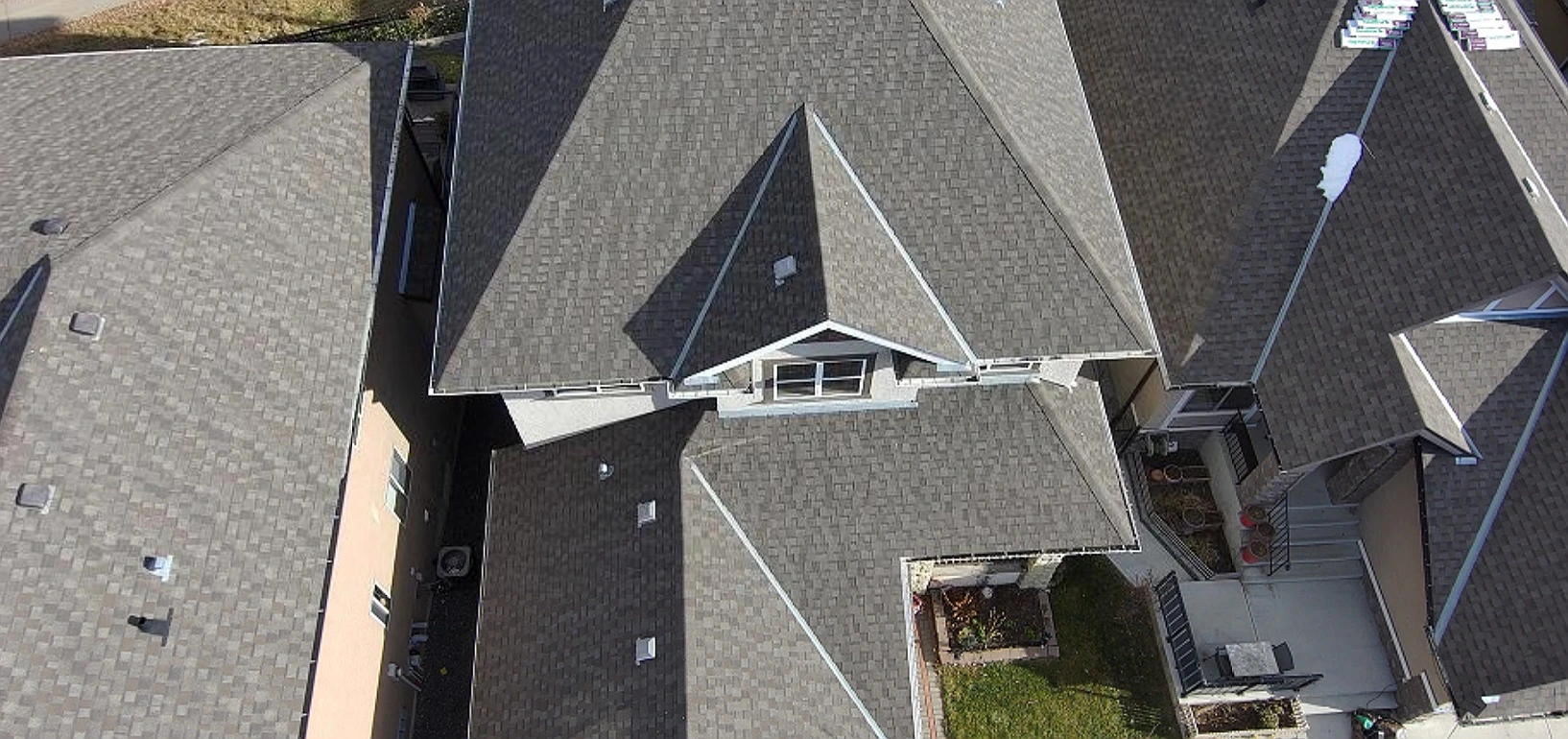 Overhead view of front roof slopes and a dormer, Tuscany, Calgary, AB