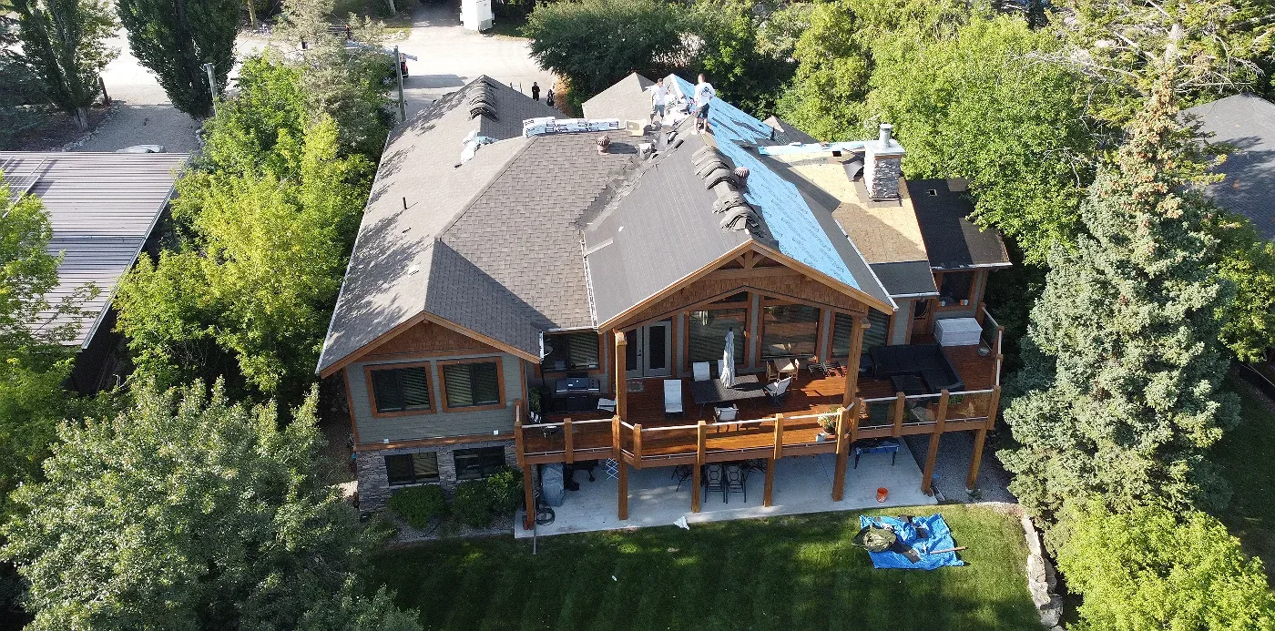 Roof tear-off in progress on a lakeside home, Windermere, BC