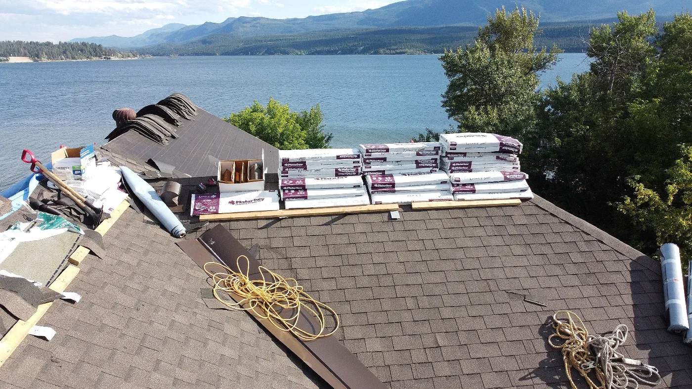 New shingle bundles staged on a roof above Lake Windermere